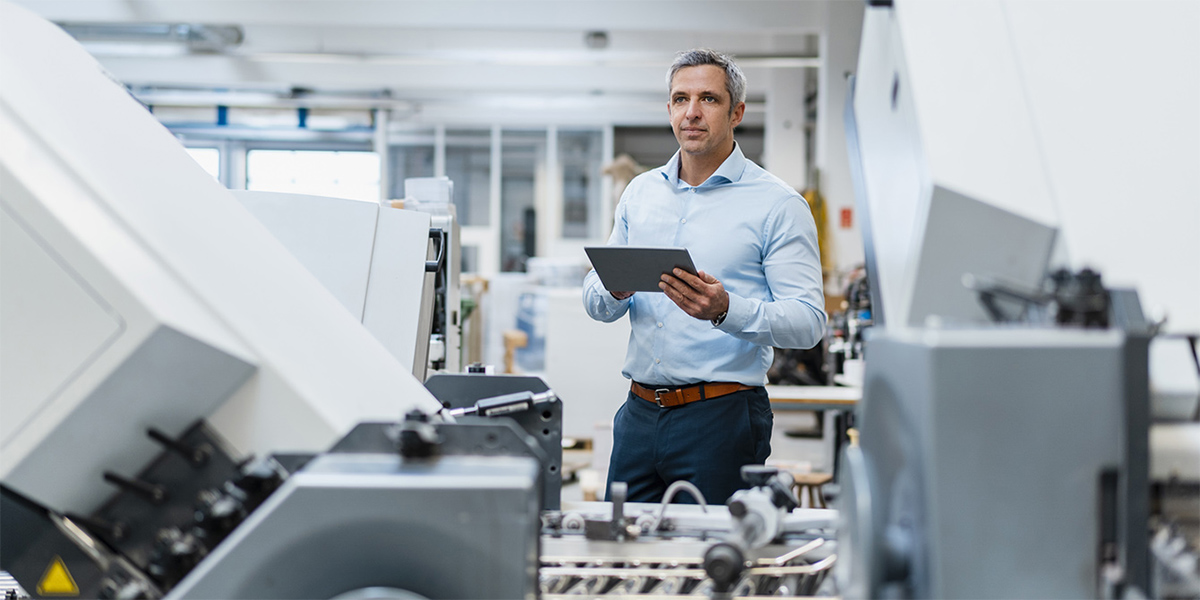 FM holds tablet CMMS | JLL Technologies fm holds tablet cmms