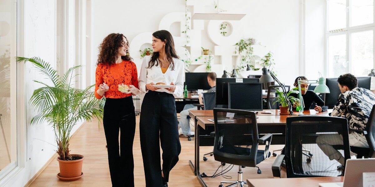 two business women walk through office space