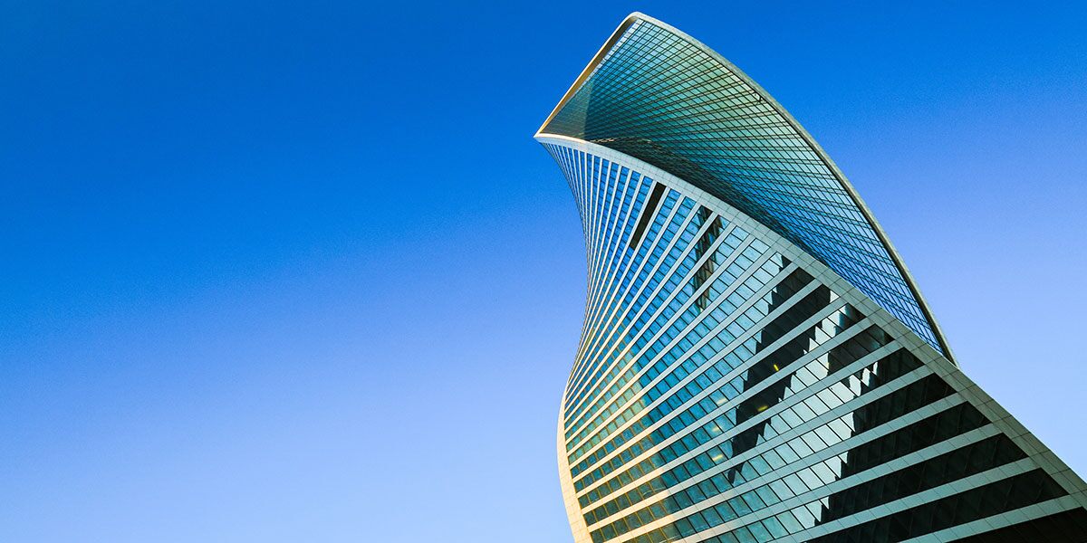 tech futuristic commercial buildings against blue sky